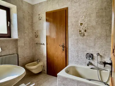 a bathroom with a shower and a toilet and a sink at Kalterer See Hof in Caldaro