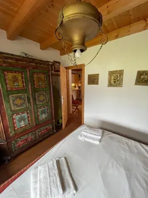 a bedroom with a bed with a light on the ceiling at Luxury panoramic apartment Plan de Corones in Tesido