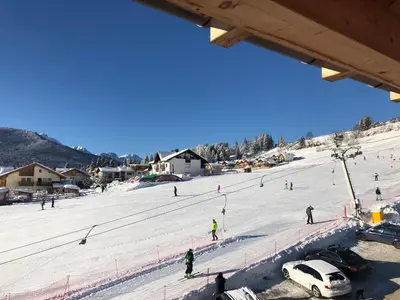 a group of people skiing on a snow covered slope at Luxury panoramic apartment Plan de Corones in Tesido