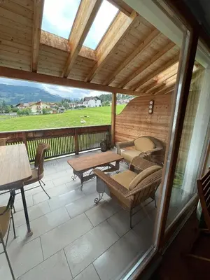 a screened in porch with a table and chairs at Luxury panoramic apartment Plan de Corones in Tesido