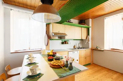 a kitchen with a table with food on it at VILLA MARGHERITA - 5 minutes from Dolomiti Super Ski in Ziano di Fiemme