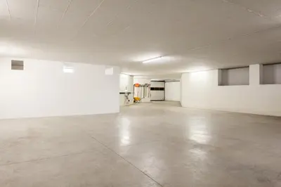an empty room with white walls and a concrete floor at VILLA MARGHERITA - 5 minutes from Dolomiti Super Ski in Ziano di Fiemme