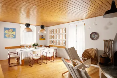 a dining room with a white table and chairs at VILLA MARGHERITA - 5 minutes from Dolomiti Super Ski in Ziano di Fiemme