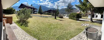 a view of a yard with a house at Ca Miramonti - Garden and Tofana view in Cortina dʼAmpezzo