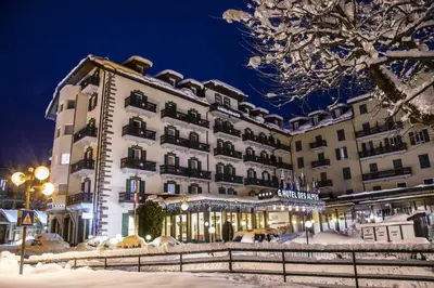 a hotel in the snow at night at G. Hotel Des Alpes (Classic since 1912) in San Martino di Castrozza