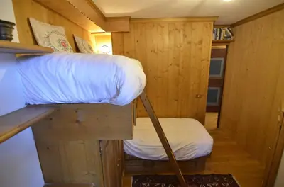 a small room with a bed and a desk at Ca novella sulla Passeggiata in Cortina dʼAmpezzo