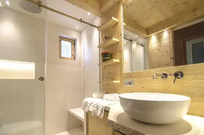 a bathroom with a white sink and a shower at Ca novella sulla Passeggiata in Cortina dʼAmpezzo