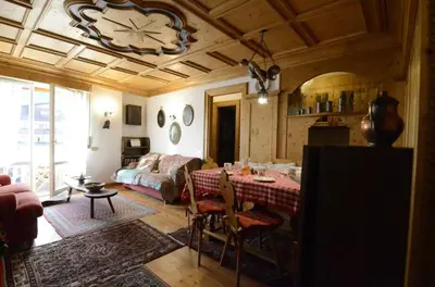 a living room with a table and a couch at Ca novella sulla Passeggiata in Cortina dʼAmpezzo