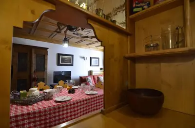 a room with a table with a red and white table cloth at Ca novella sulla Passeggiata in Cortina dʼAmpezzo