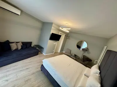 a living room with a bed and a couch at Villa Jasmine in Bolzano