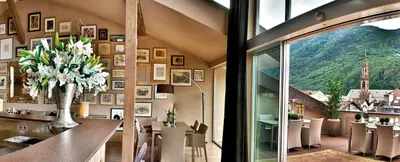 a room with a table with a vase of flowers at Loft Thaler Rooms in Bolzano