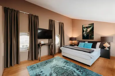 a bedroom with a bed and a television in it at Loft Thaler Rooms in Bolzano
