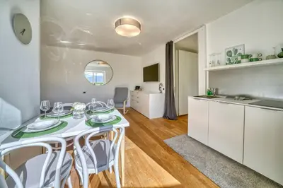 a kitchen and dining room with a table and chairs at HOMESTWENTY3 - Home three in Caldaro