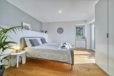 a white bedroom with a bed and a potted plant at HOMESTWENTY3 - Home three in Caldaro