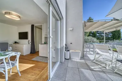 a living room with a patio with a table and chairs at HOMESTWENTY3 - Home three in Caldaro