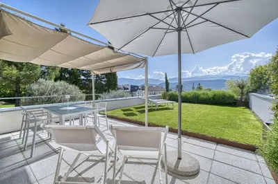 a patio with a table and chairs and an umbrella at HOMESTWENTY3 - Home three in Caldaro