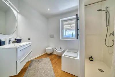 a bathroom with a toilet and a sink and a shower at HOMESTWENTY3 - Home three in Caldaro