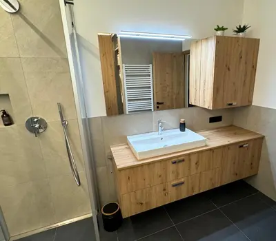 a bathroom with a sink and a shower at Renesmee Apartment in Naturno