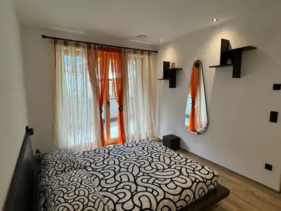 a bedroom with a bed in front of a window at Renesmee Apartment in Naturno