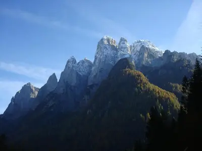 a mountain range with trees in front of it at Casa Adriana in Agordo