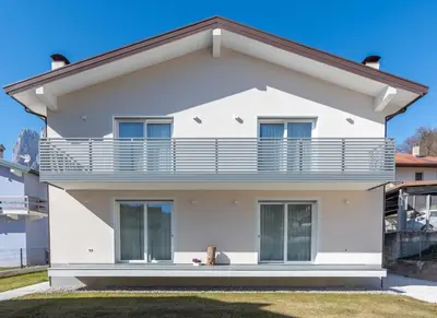 a white house with a large balcony at Casa Adriana in Agordo