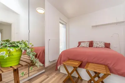 a bedroom with a bed and a potted plant at Casa Adriana in Agordo