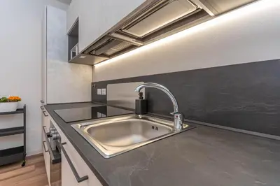 a kitchen with a stainless steel sink in a kitchen at Casa Adriana in Agordo