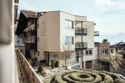 a view from the balcony of a building with a garden at Hilburger Hotel in Schenna