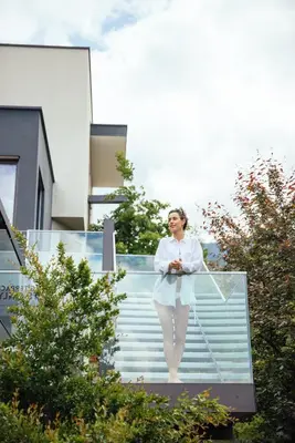 a woman in a white dress walking down some stairs at Hilburger Hotel in Schenna