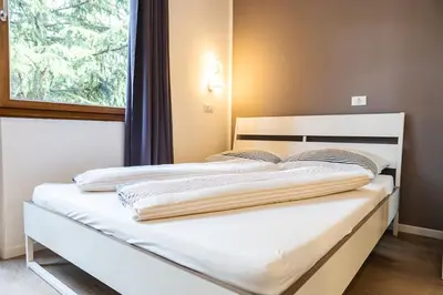 a bed in a room with a window at Flow Apartments WINKEL STUDIO in Merano