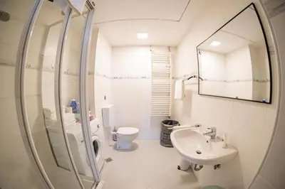 a bathroom with a sink and a toilet and a mirror at Flow Apartments WINKEL ATELIER in Merano