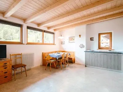 a kitchen and dining room with a table and chairs at Apartment Ciampedie by Interhome in Pera