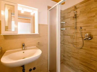 a bathroom with a sink and a toilet and a mirror at Apartment Ciampedie by Interhome in Pera
