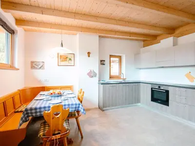 a dining room with a table and a desk at Apartment Ciampedie by Interhome in Pera