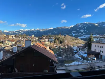 a view of a city with mountains in the background at Il Focolare del Cermis in Cavalese
