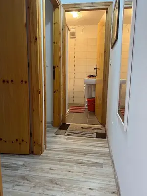 a hallway of a bathroom with wooden walls and a floor at Il Focolare del Cermis in Cavalese