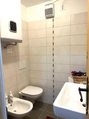 a bathroom with a toilet and a sink at Il Focolare del Cermis in Cavalese