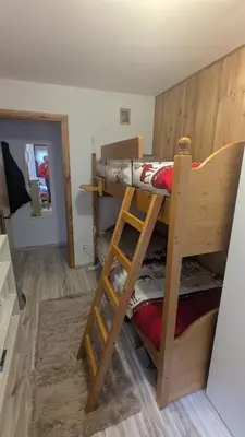 a room with two bunk beds in a room at Il Focolare del Cermis in Cavalese