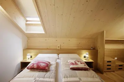 a flat screen tv sitting on top of a wooden cabinet at ALPINE LOFT - Residence Veronza con piscina, Dolomiti Affitti in Cavalese