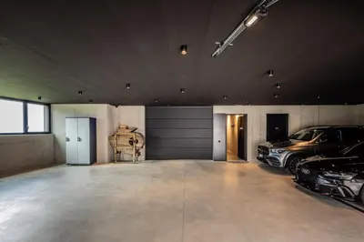 a garage with two cars parked in it at Tagenhof Mountain Living in Meluno