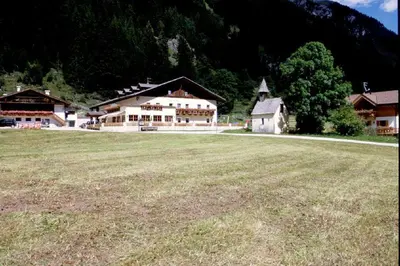 a large field with a large building in the background at Hotel Larchhof Ratschings in Racines