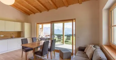 a kitchen and dining room with a table and chairs at Oberpfaffstaller in Longomoso