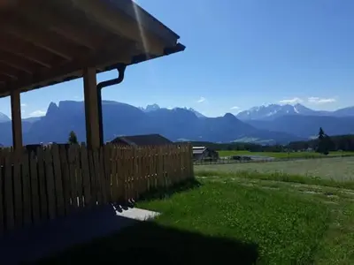 a wooden fence with mountains in the background at Oberpfaffstaller in Longomoso