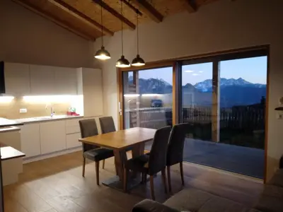 a kitchen and dining room with a table and chairs at Oberpfaffstaller in Longomoso
