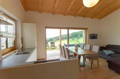 a kitchen and living room with a table and a couch at Oberpfaffstaller in Longomoso