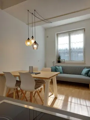 a kitchen and living room with a table and chairs at Villa Trogmann in Merano