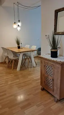 a dining room with a wooden table and chairs at Villa Trogmann in Merano
