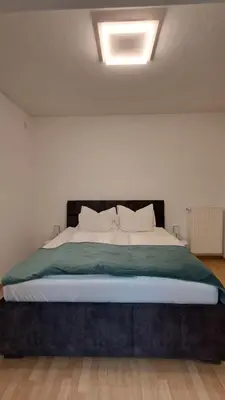 a bedroom with a large bed with a white bed sidx sidx sidx at Villa Trogmann in Merano