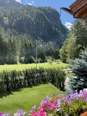 a view of a park with mountains in the background at Cesa Mattias - Appartamenti a Canazei in Canazei
