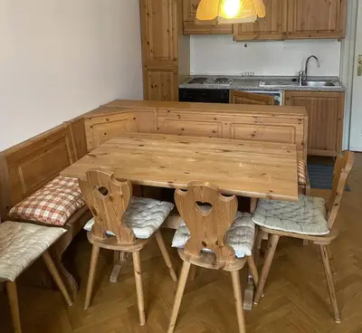 a wooden table and chairs in a kitchen at Appartament Brennero in Colle Isarco